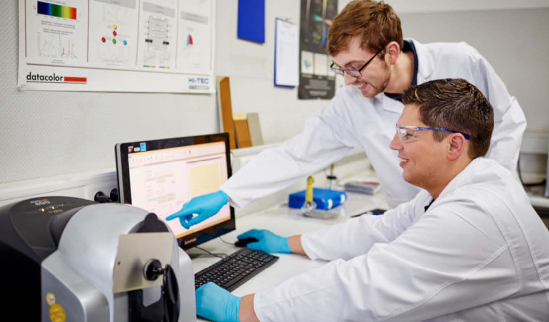 coating laboratory team in front of a computer